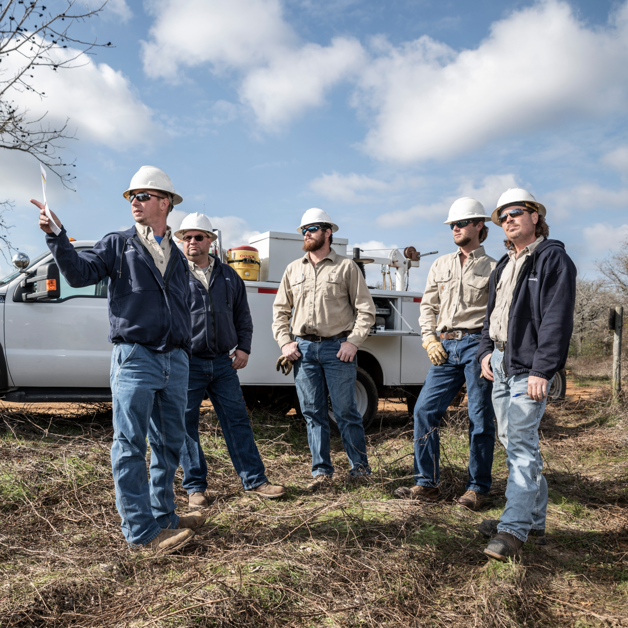 lineworker grew huddling with one man pointing